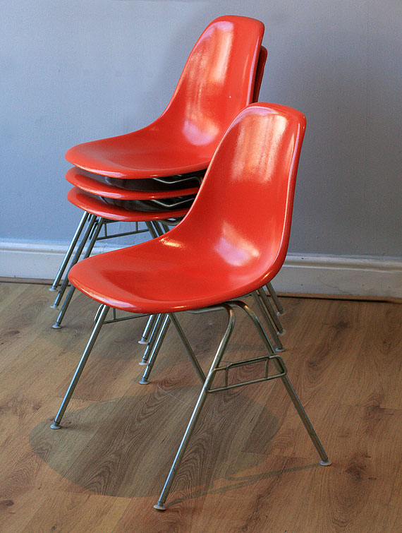 Orange Eames stacking shell chairs